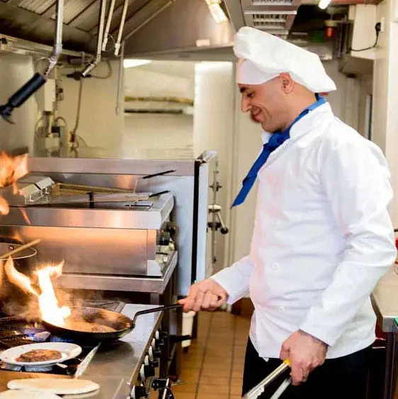 Stoneybrook Lodge Chef Created Meals, chef frying a dish.