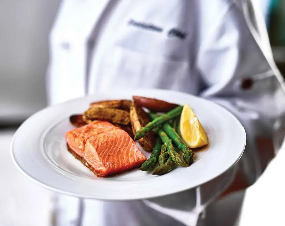 Stoneybrook Lodge Chef Created Meals, chef delivering a finished dish.